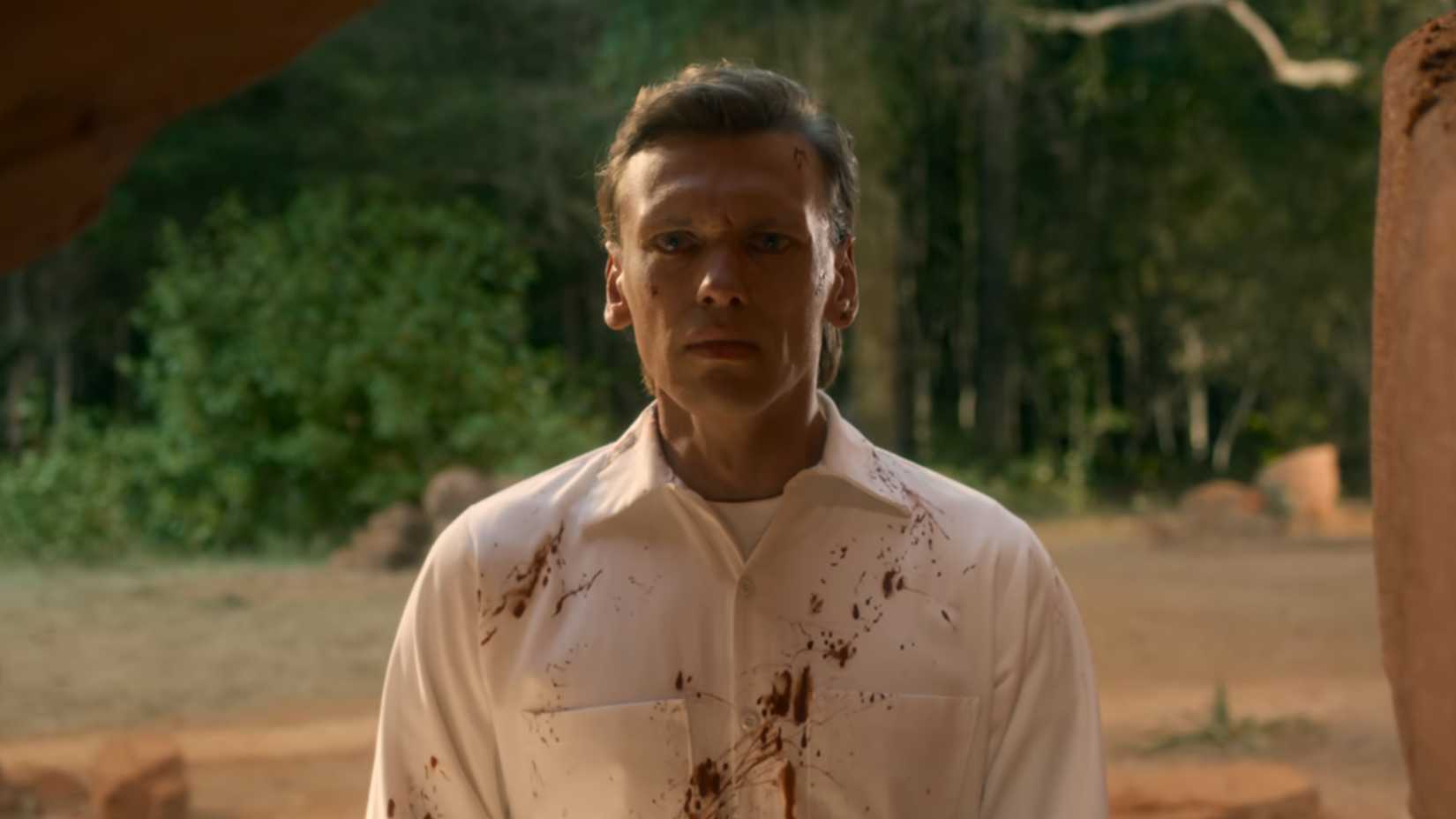Jamie Campbell Bower as Henry Creel looking terrified at the cave entrance in Stranger Things season 5.