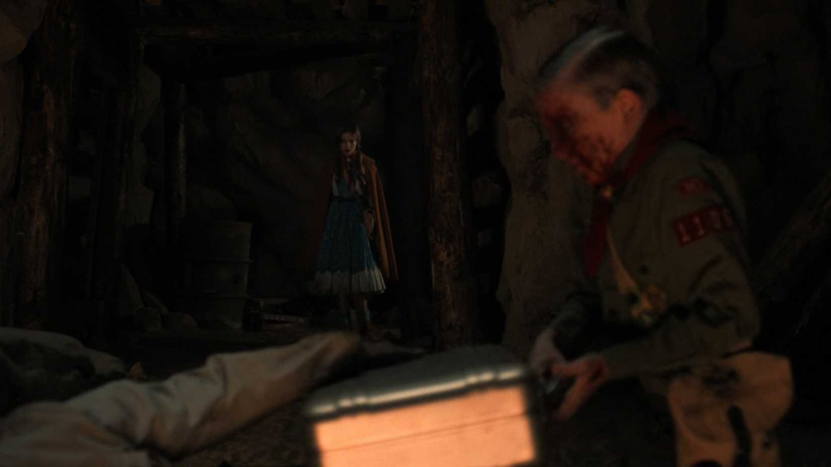 Raphael Luce as young Henry Creel opening a briefcase in front of Nell Fisher as Holly in Stranger Things. 
