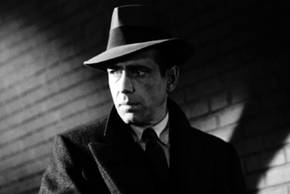 Humphrey Bogart standing in the shadows in The Maltese Falcon
