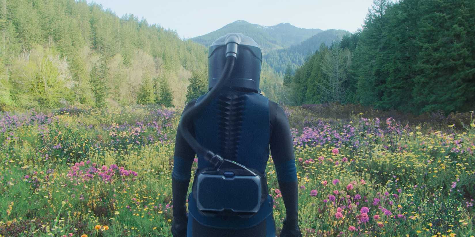 Someone in a hazmat suit walking through a field In the Blink of an Eye