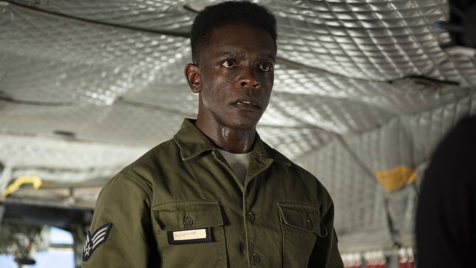Dick Hallorann (Chris Chalk) in uniform and standing on aircraft in IT: Welcome to Derry