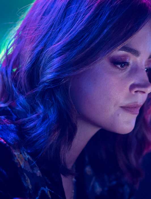 Jenna Coleman looking down at her phone in Wilderness