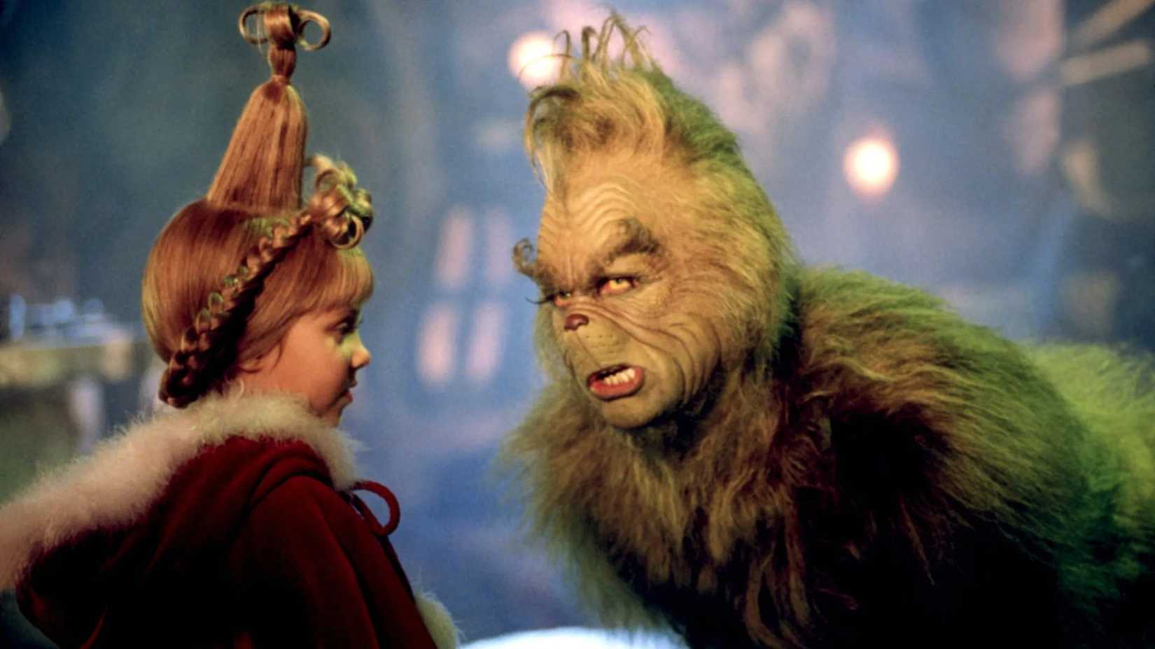 Jim Carrey as the Grinch talking to Taylor Momsen as Cindy Lou Who in How the Grinch Stole Christmas