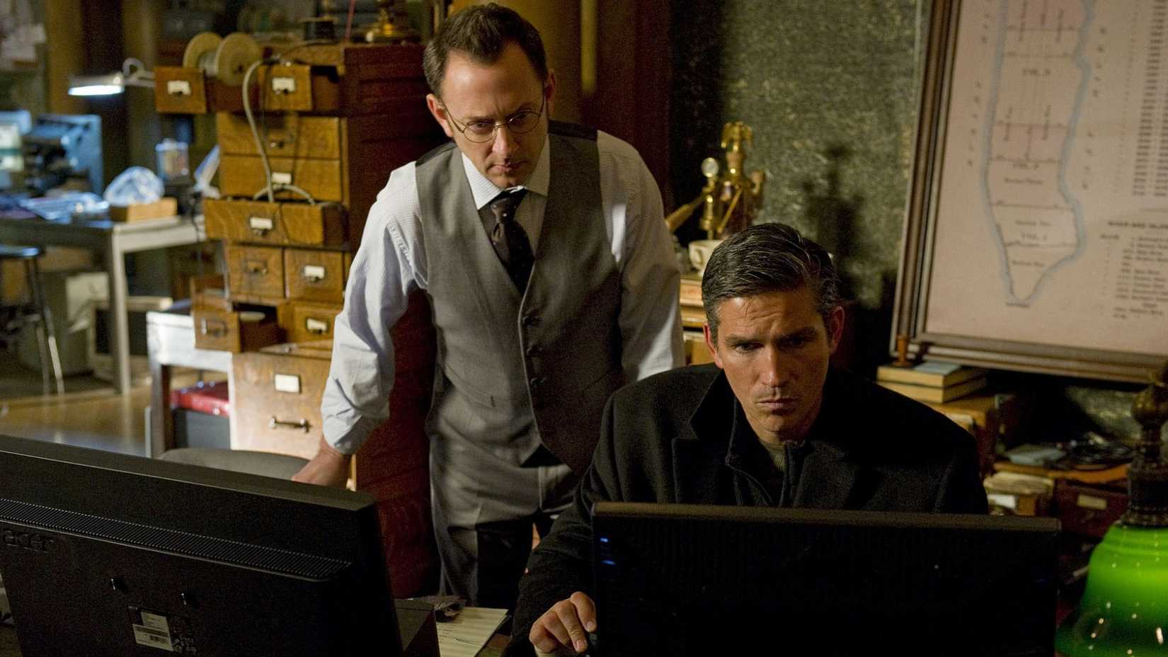11 TV Shows We Thought Would Be The Next Lost 1 Reese (Jim Caviezel) and Finch (Michael Emerson) look at a computer in Person of Interest.