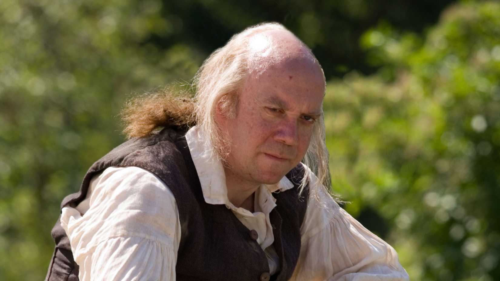 An elderly John Adams (Paul Giamatti) lost in thought in John Adams.