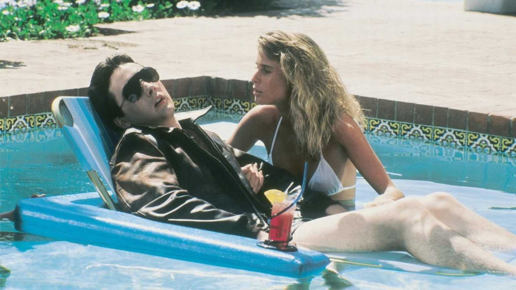 John Cusack in the pool as Gib with Nicollette Sheridan looking at him in The Sure Thing