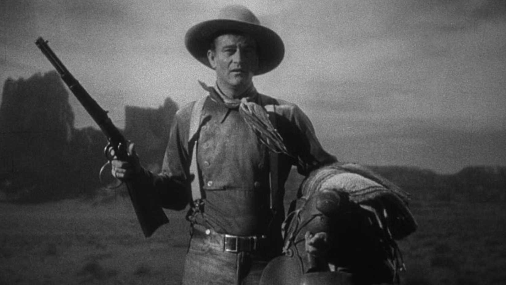 John Wayne como The Ringo Kid com um rifle em Stagecoach