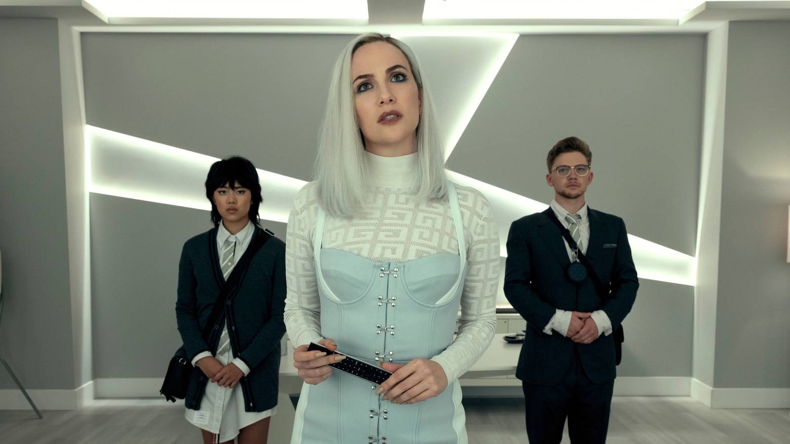 Kate Siegel's character stands between her two assistants in The Fall of the House of Usher