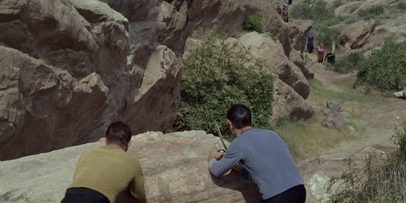Kirk and Spock hiding behind rocks in Star Trek The Original Series