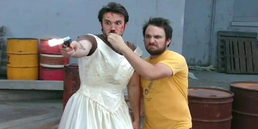 Mac in a wedding dress firing a gun in It's Always Sunny in Philadelphia
