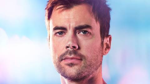 Matt Long as Zeke Landon looking at the screen in Manifest.