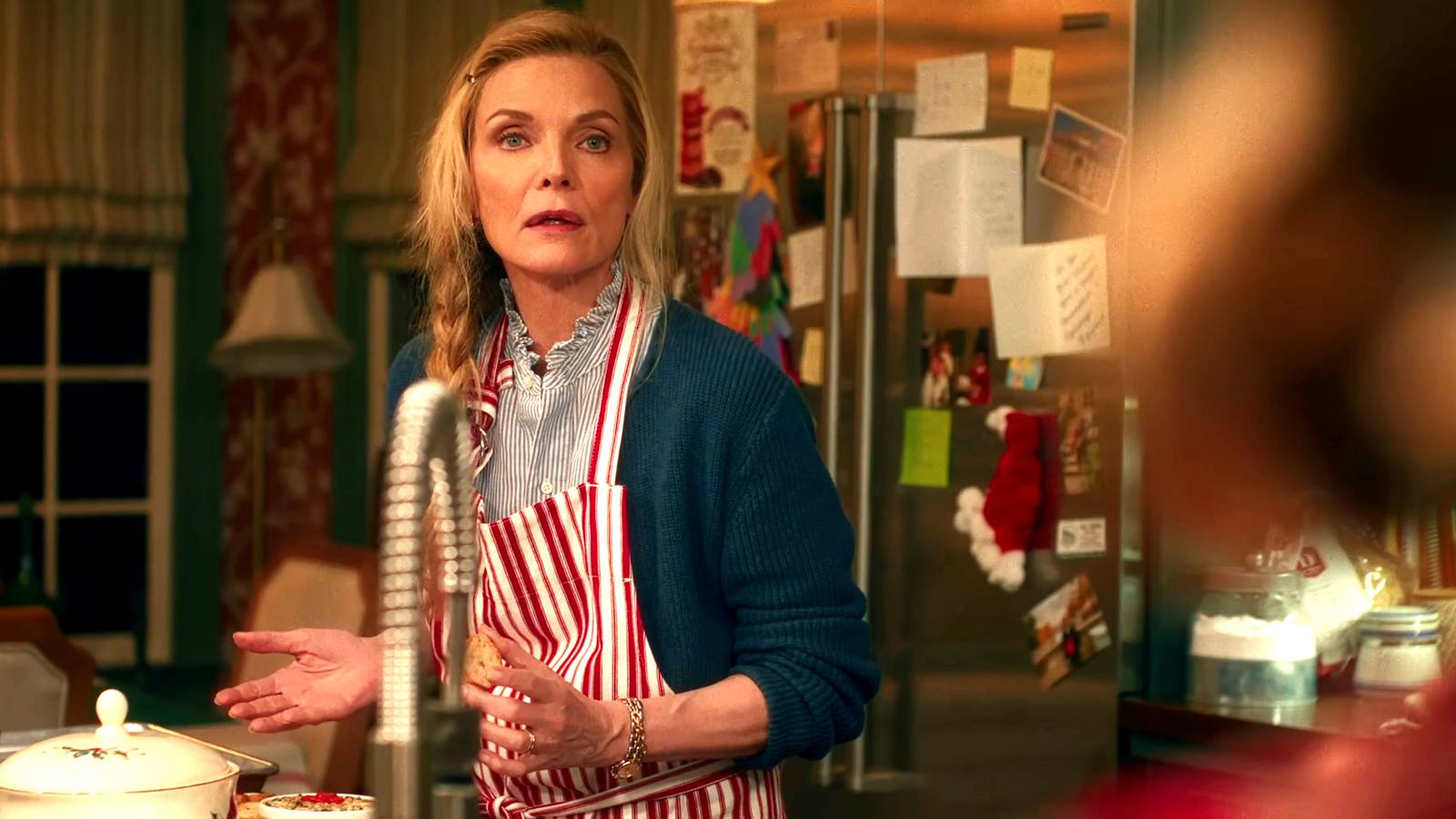 Michelle Pfeiffer as Claire looking frustrated while in the kitchen in Oh What Fun
