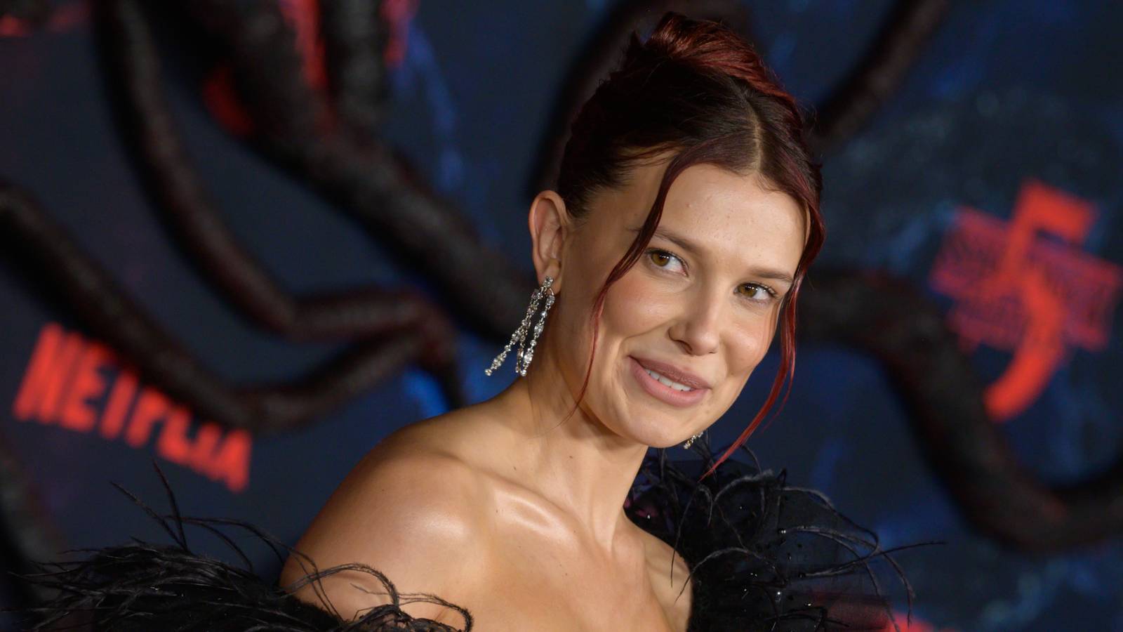 Millie Bobby Brown smiling at the Stranger Things season 5 premiere