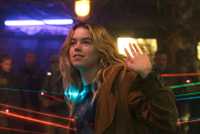 Milly Alcock as Supergirl with guns pointed at her