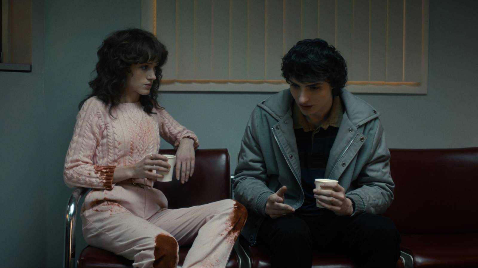 Nancy and Mike sitting together in the hospital waiting room in Stranger Things season 5