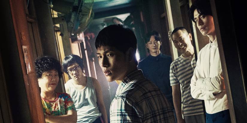 Neighbors stand in a hallway in Strangers from Hell