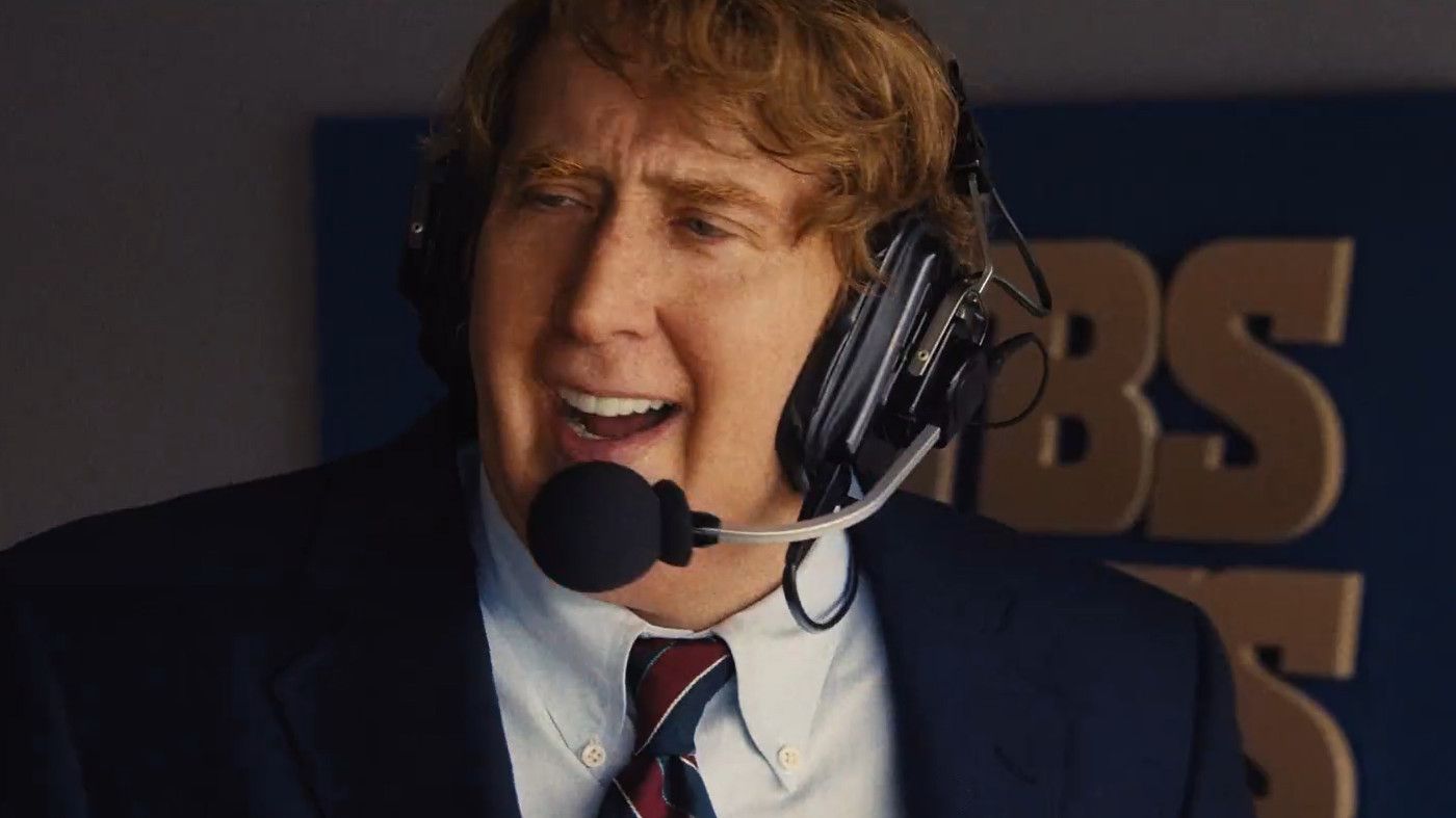 Nicolas Cage talks while wearing an audio headset in a scene from Madden