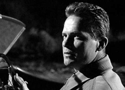 Ralph Meeker as Mike Hammer in a car in Kiss Me Deadly
