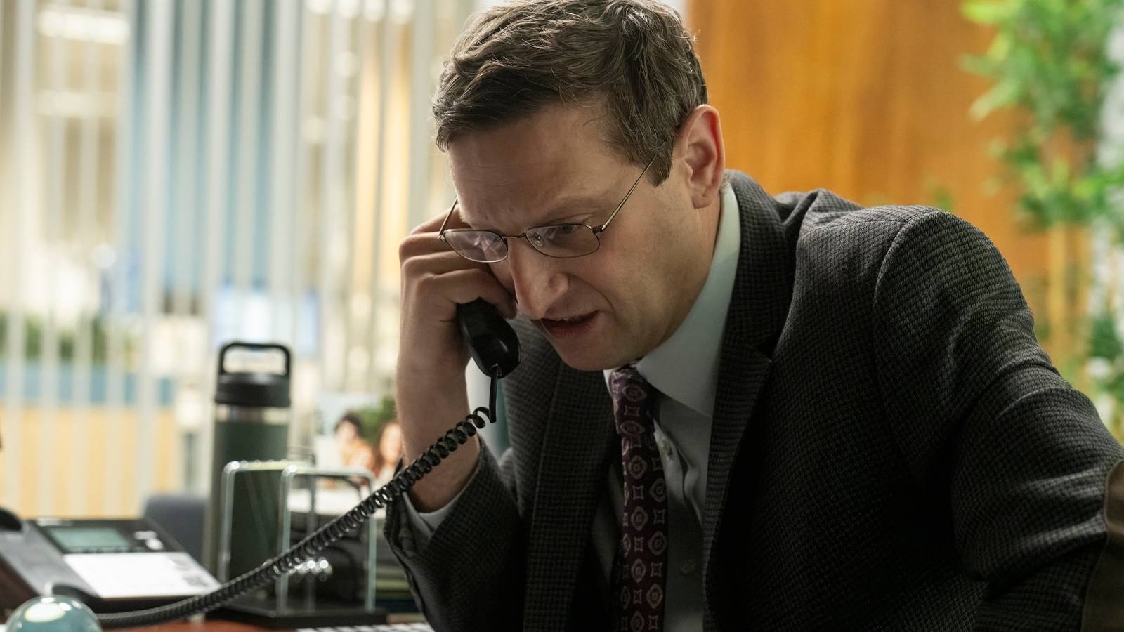 Ron looking distressed on the phone in The Chair Company