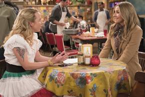 Roseanne's Lecy Goranson and Sarah Chalke sitting at a table.