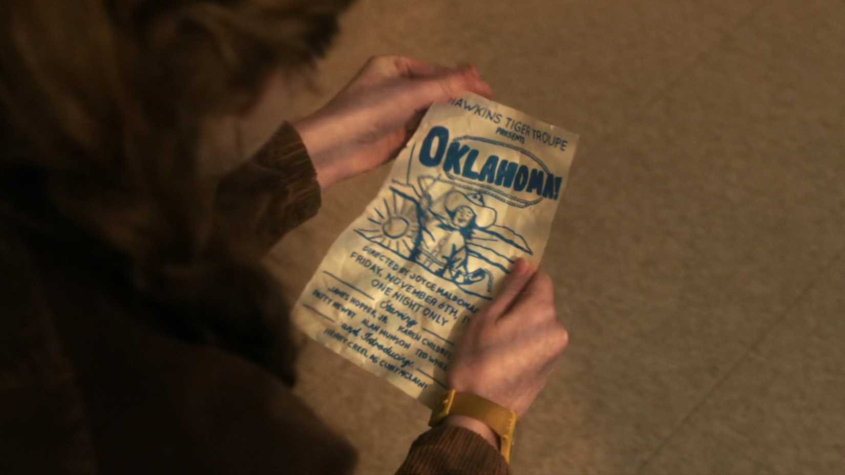 Sadie Sink as Max holding a poster for Joyce's play in Stranger Things season 5. 