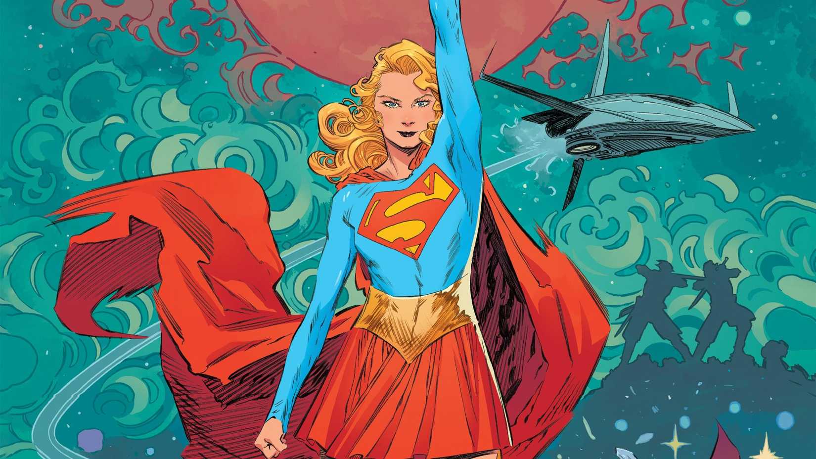 Supergirl raising her hand up high and smiling. 