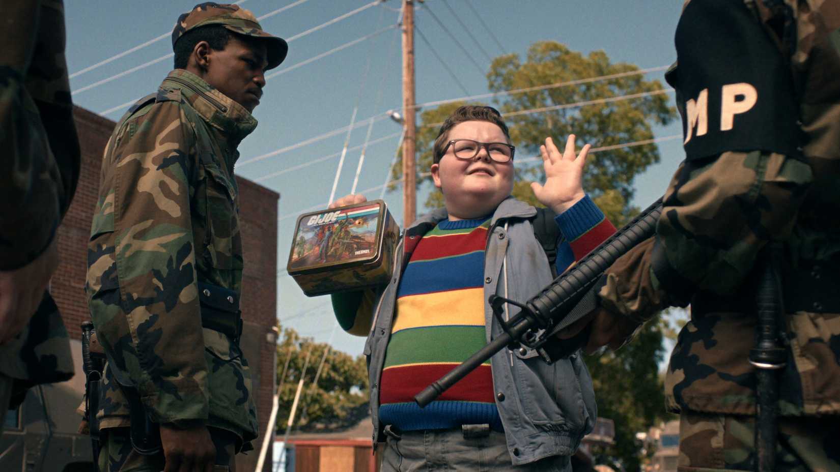 15 Stars We're Excited to See at MEGACON Orlando 2026 1 Derek (Jake Connelly) raising his hands in surrender in Stranger Things season 5