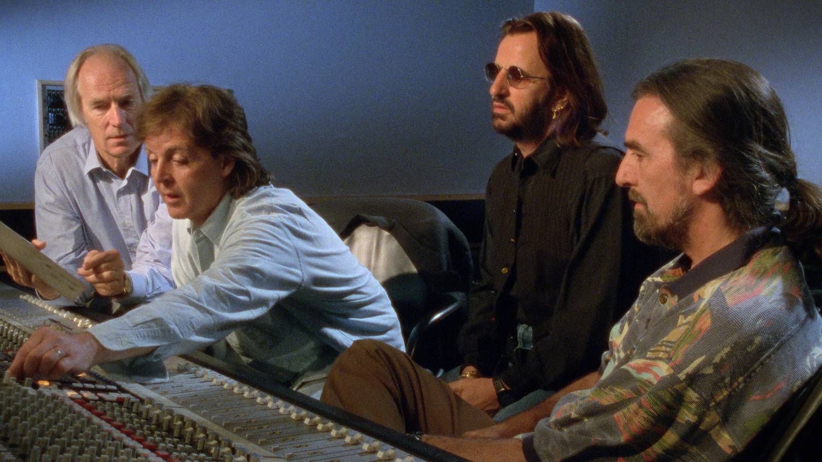 George Martin, Paul McCartney, Ringo Starr and George Harrison at a mixing desk in The Beatles Anthology