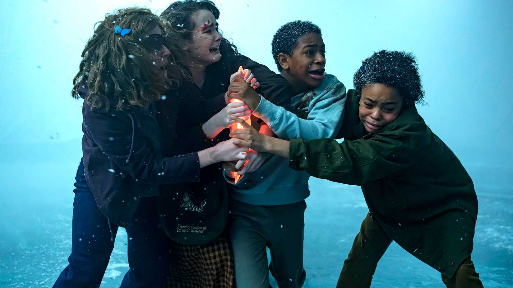 the kid group struggling over the meteor shard on the frozen lake in it welcome to derry episode 8