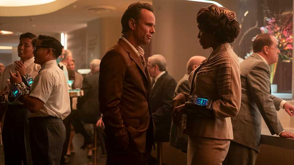 Walton Goggins' Cooper and Frances Turner's Barb standing close to each other at a New Vegas party in Fallout season 2