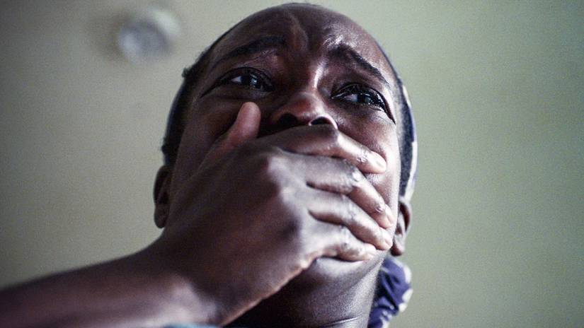 Wunmi Mosaku shot from below covering her mouth in horror in His House