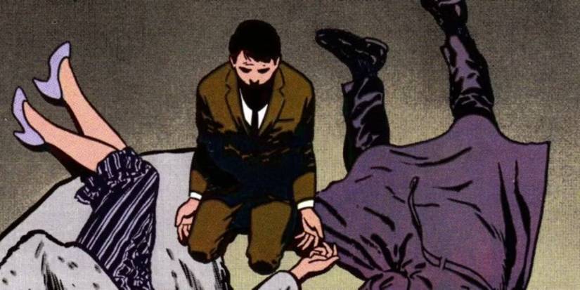 Young Bruce Wayne kneels by the bodies of his death parents