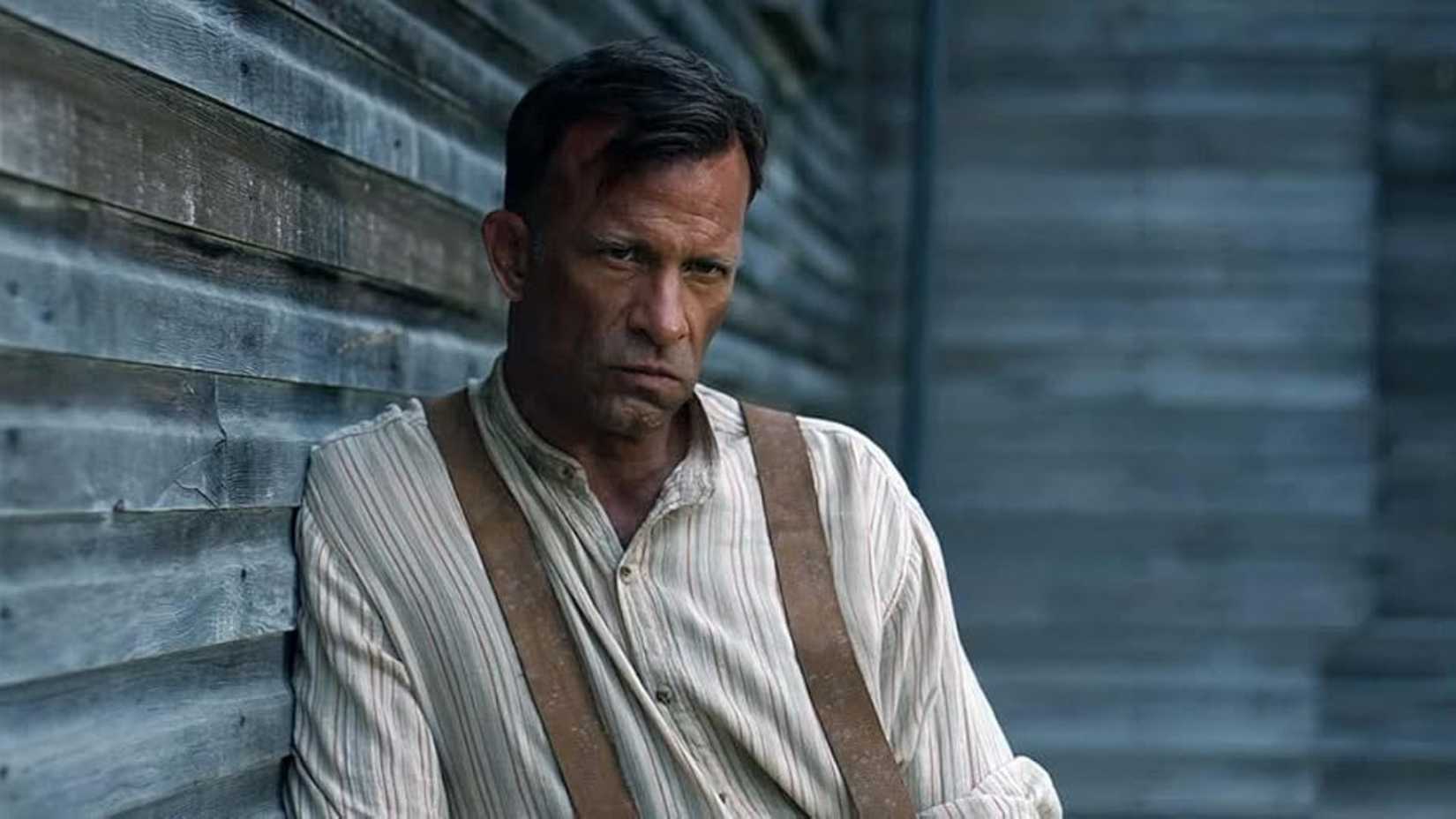 Thomas Jane leans against a wall in 1922