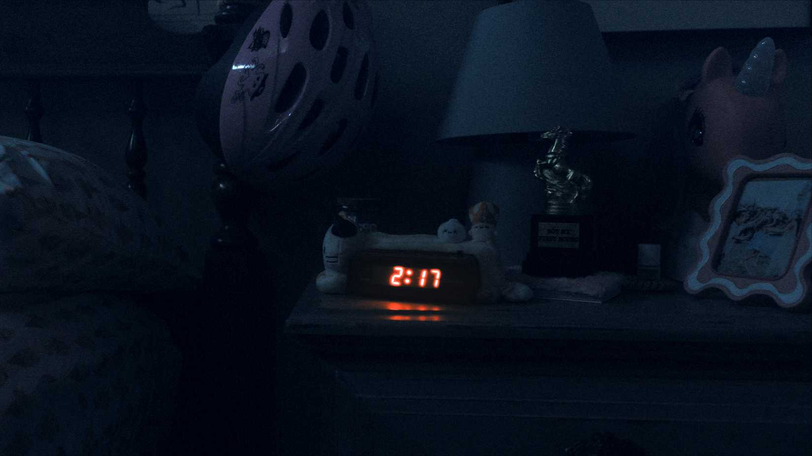 A digital clock at 2-17 am in Weapons 2025
