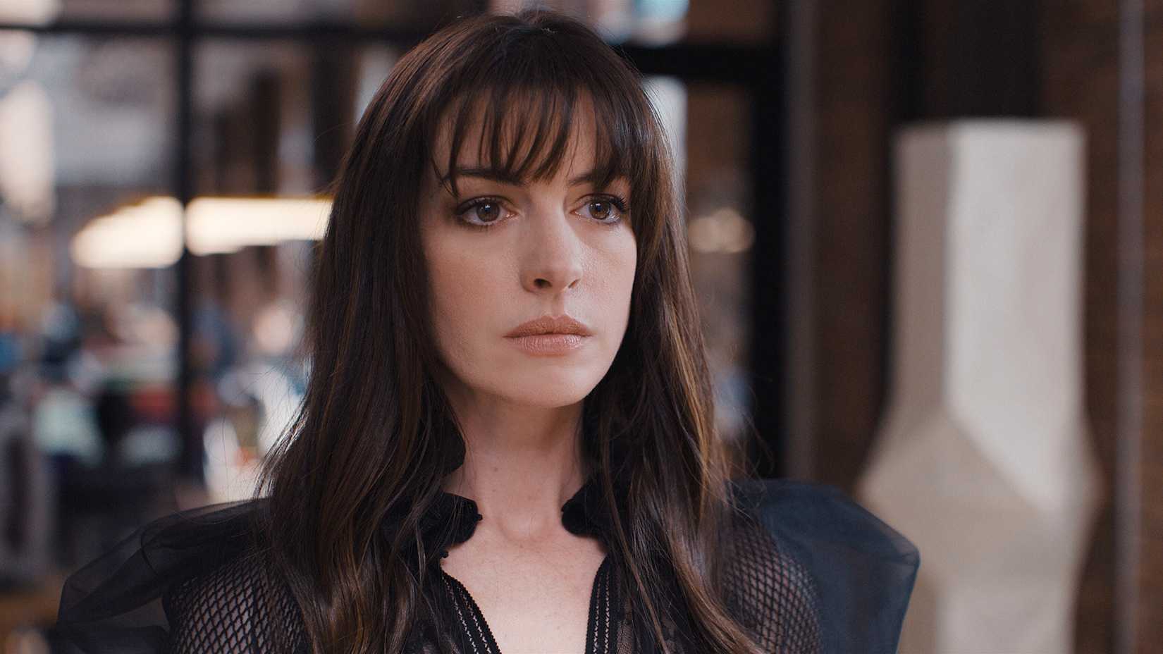 Anne Hathaway looking ahead in a scene from WeCrashed