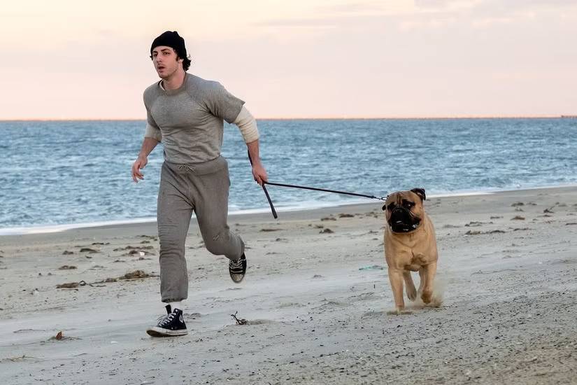 Anthony Ippolito as young Sylvester Stallone running on the beach in I Play Rocky