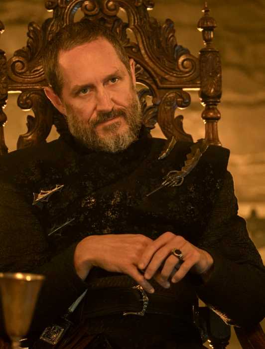 Bertie Carvel sitting in a chair in A Knight of the Seven Kingdoms