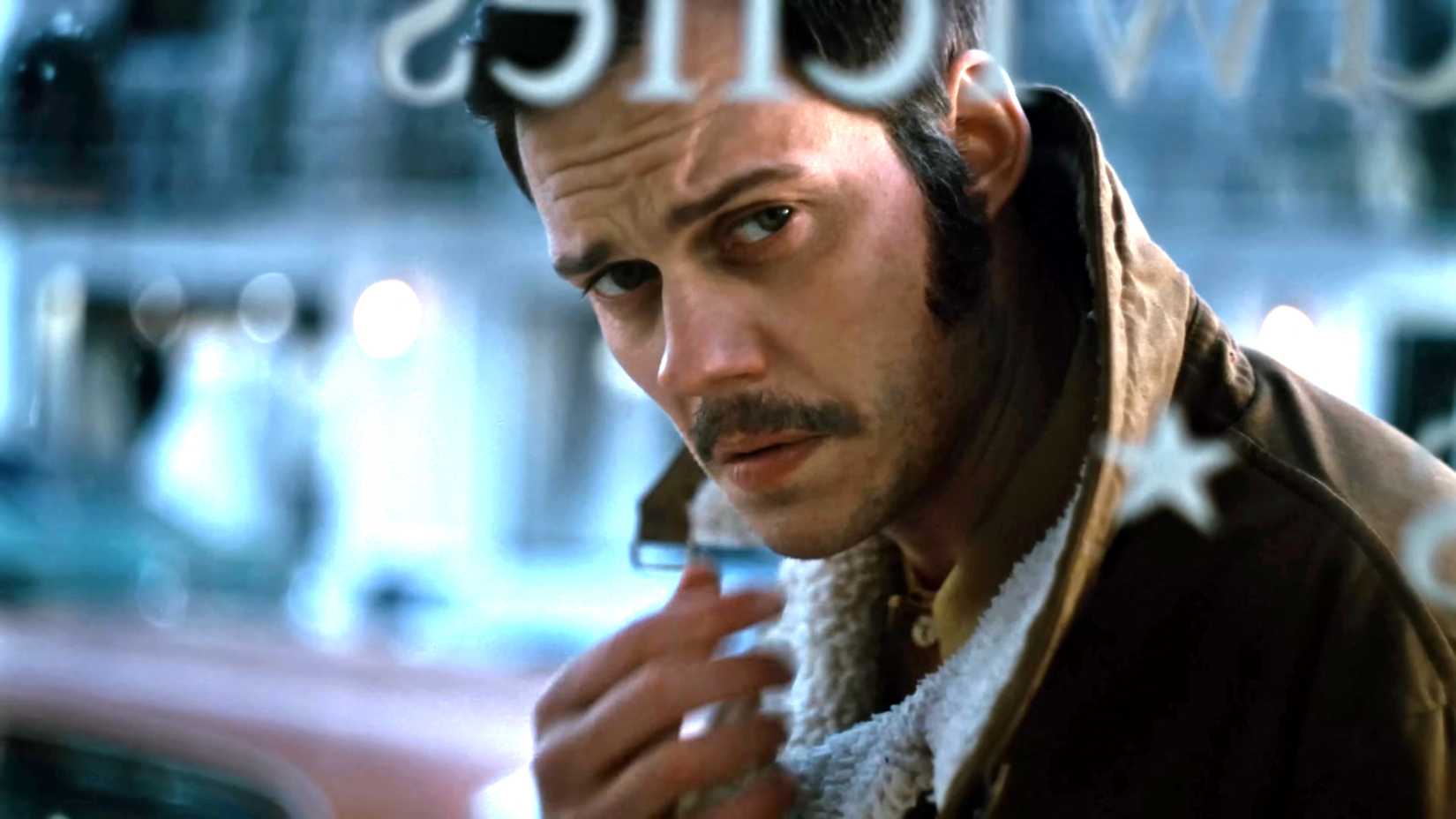 Bill Skarsgård's Tony looking dramatically into a window in Dead Man's Wire