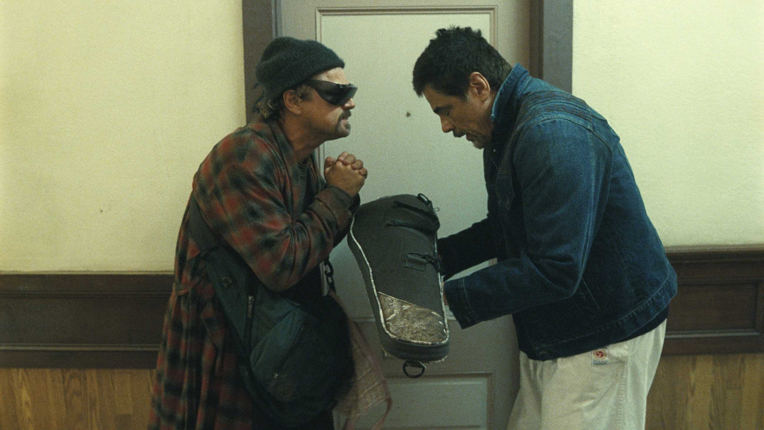 Bob and Sensei bowing at each other as Sensei gives him his rifle in One Battle After Another