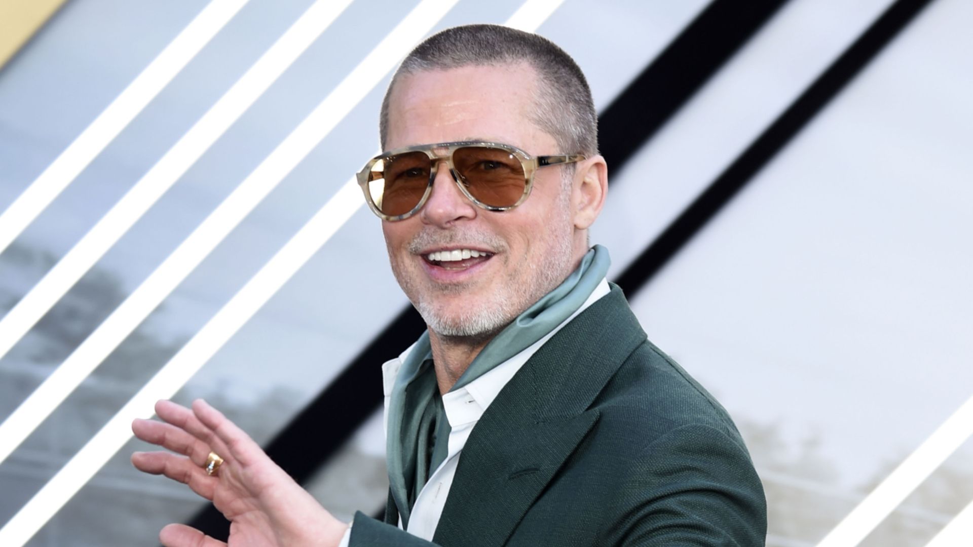 Brad Pitt smiling and waving at the European premiere of F1