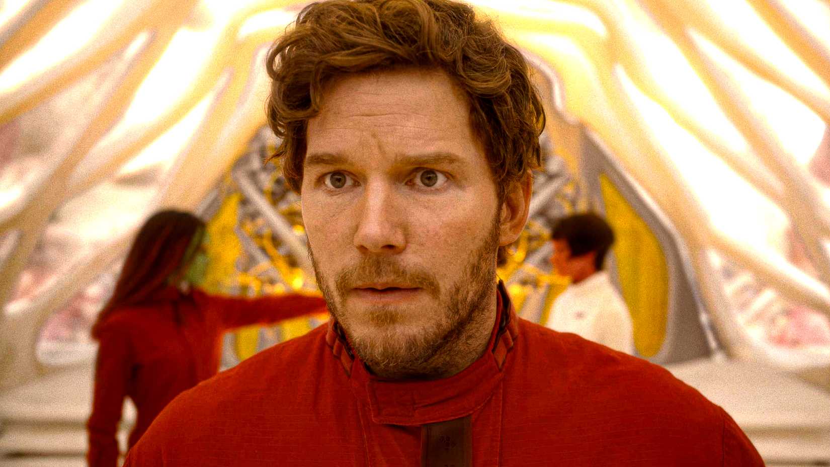 Chris Pratt's Star-Lord looking worried while Gamora holds someone at gunpoint in the background in Guardians of the Galaxy Vol. 3