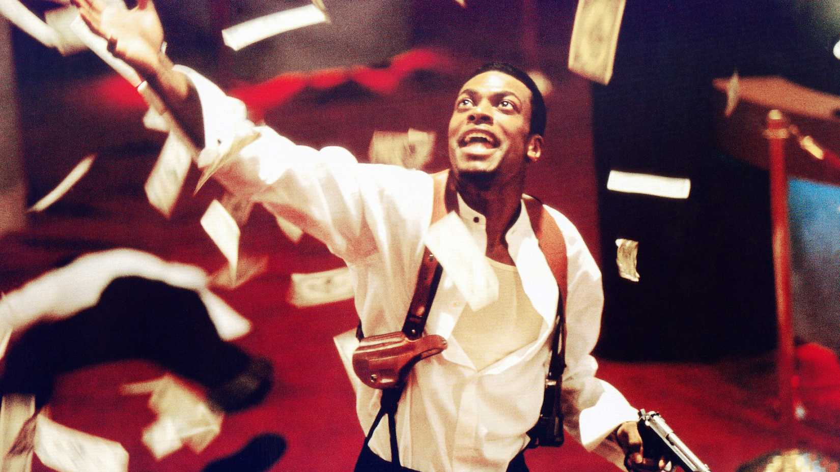 Chris Tucker looks up while money rains down around him in a scene from Rush Hour