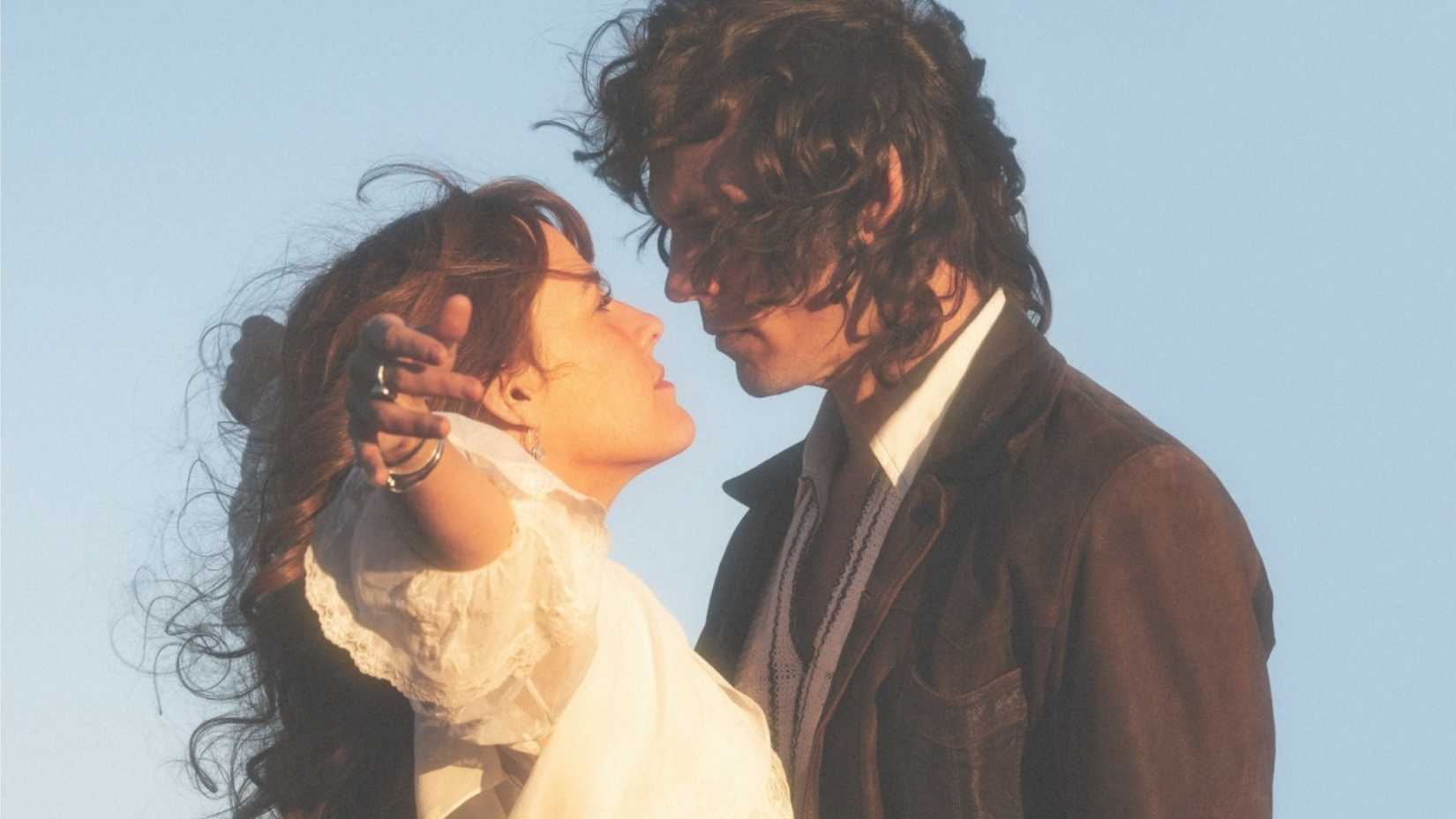 Daisy Jones and Billy Dunne staring into each other's eyes in Daisy Jones & the Six