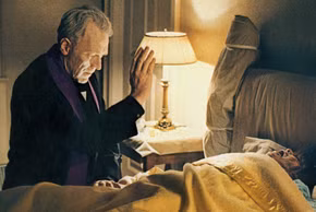 Father Merrin blessing a possessed Regan in The Exorcist