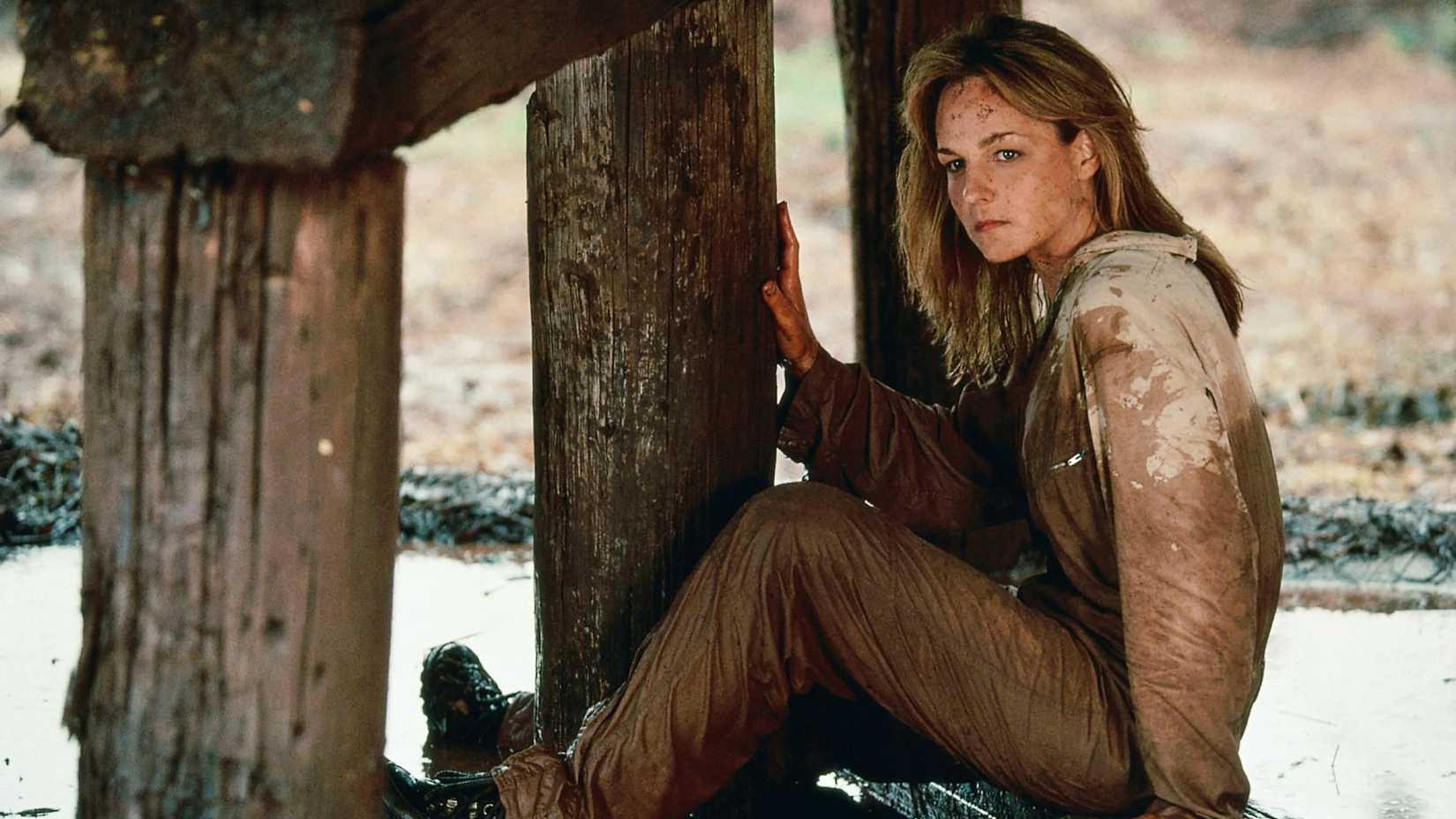 helen hunt s jo looking intensely while sitting in a destroyed structure in twister