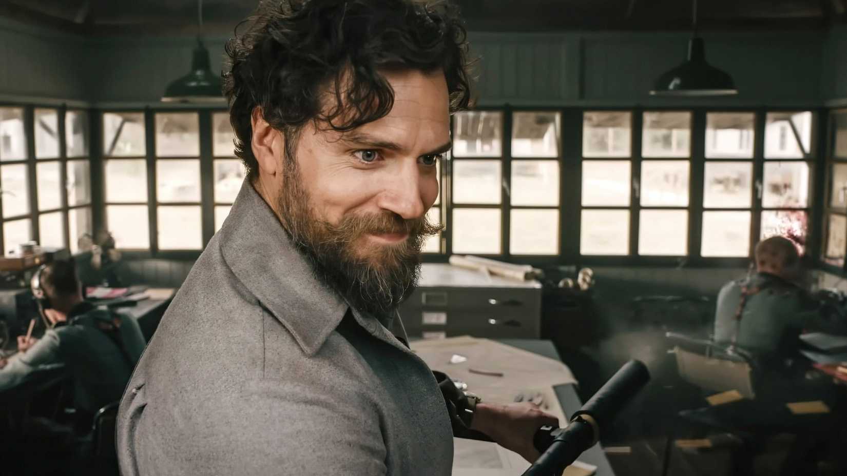 henry cavill gleefully shooting his weapon in the ministry of ungentlemanly warfare