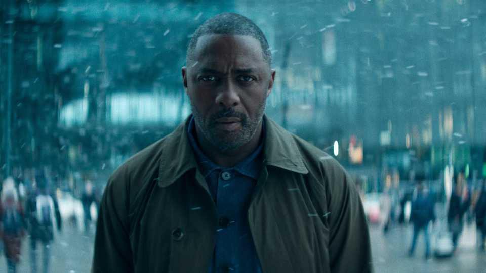 Idris Elba looking ahead while standing in the snow in Hijack season 2 episode 1