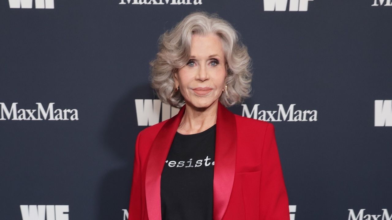 Jane Fonda wears a black t-shirt that reads 