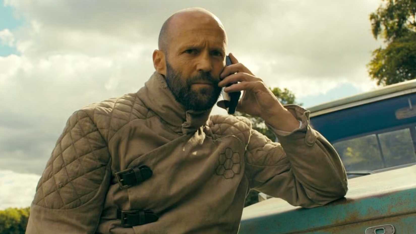 Jason Statham talking on the phone in The Beekeeper