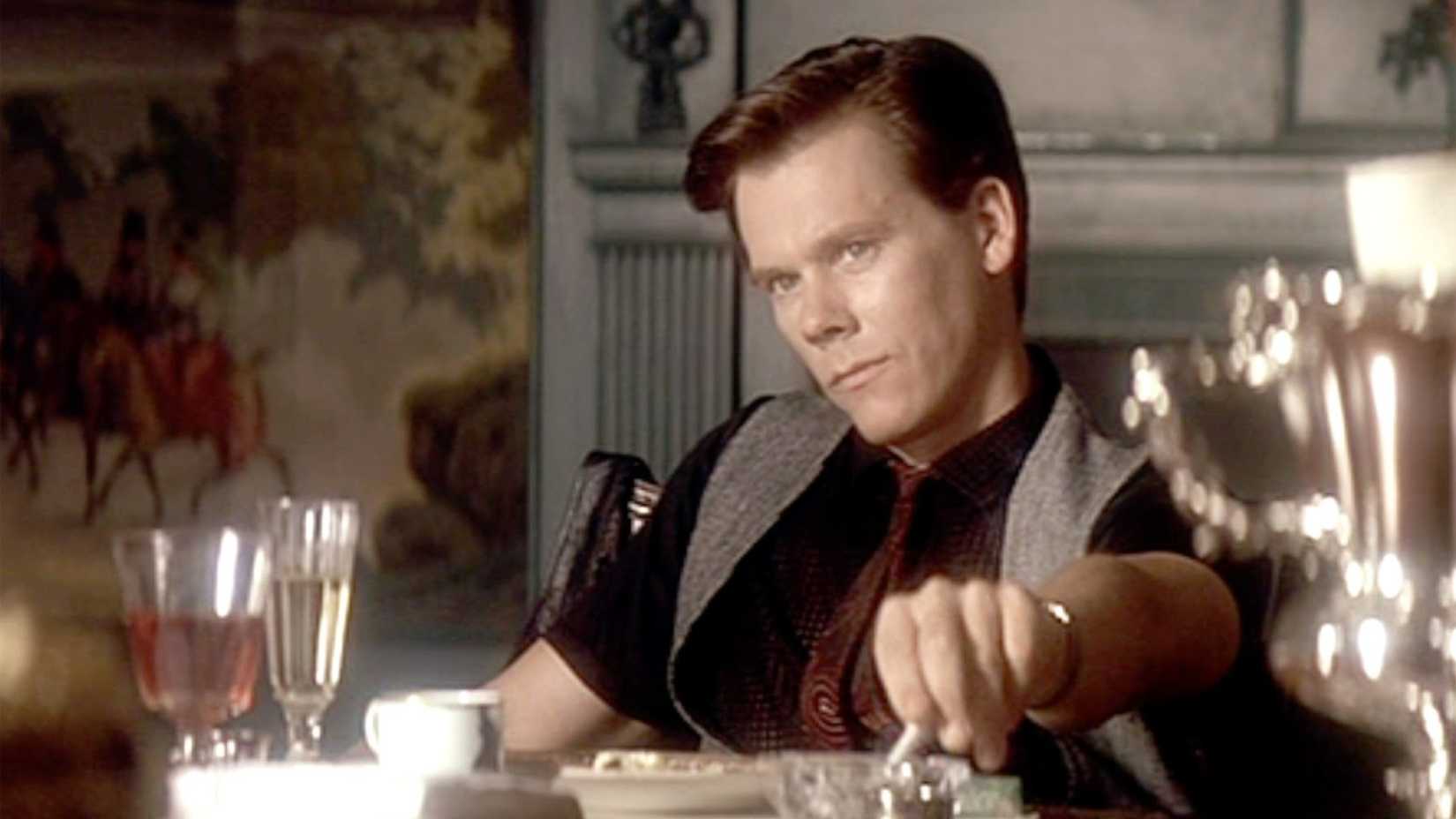 Kevin Bacon snubs out his cigarette in JFK